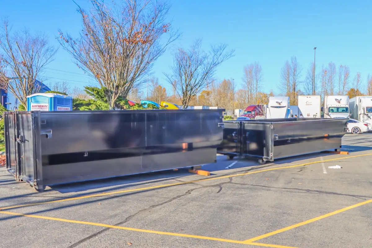 Professional dumpster rental service with roll-off container on residential driveway in Granger